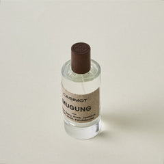 Bottle of Casimot Mugung fragrance on a light beige background